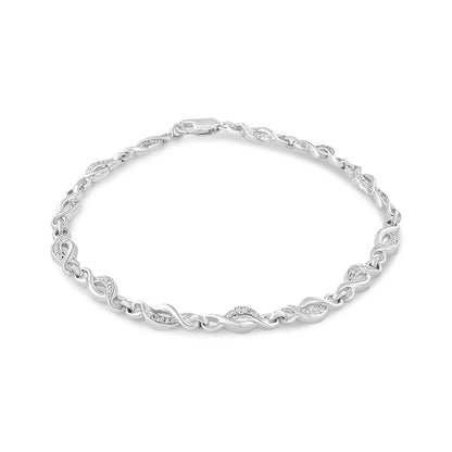 White metal bracelet with alternating twisted links and links set with small white gemstones, shown from a top front angle.
