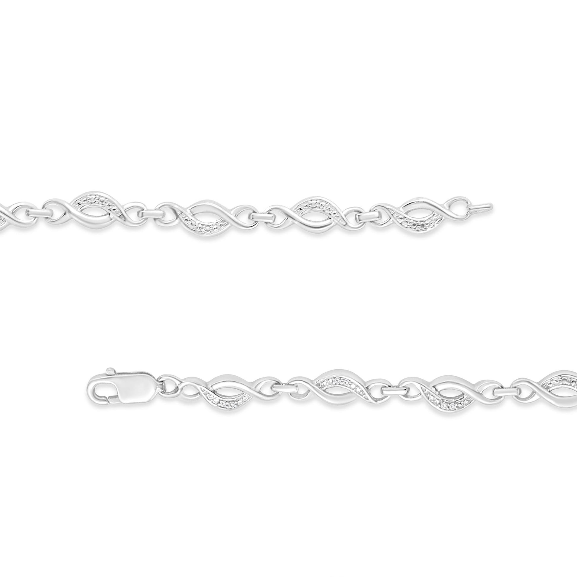 White metal bracelet with interlocking infinity-shaped links, some featuring small white gemstones, viewed flat from above.
