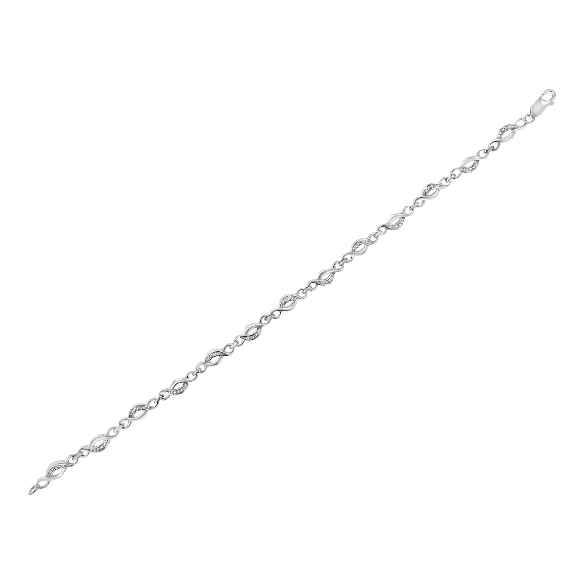 White metal bracelet with alternating twisted links, some adorned with small white gemstones, shown in flat lay angled view.