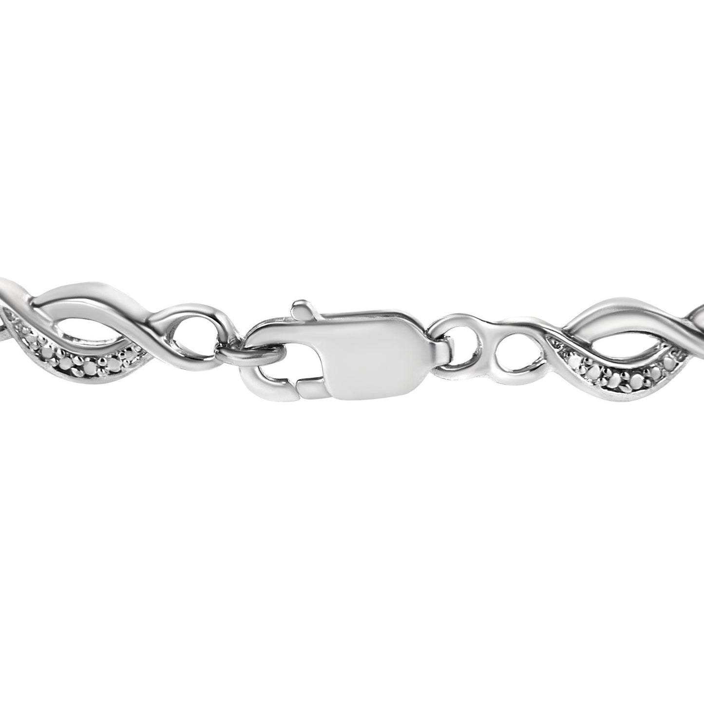 Close-up side angle of a white metal bracelet with an interwoven design and two white round gemstones in prong settings near the clasp.
