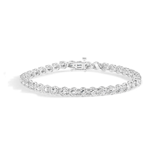 Front angle view of a white metal bracelet with round white gemstones in prong settings arranged along the entire band.