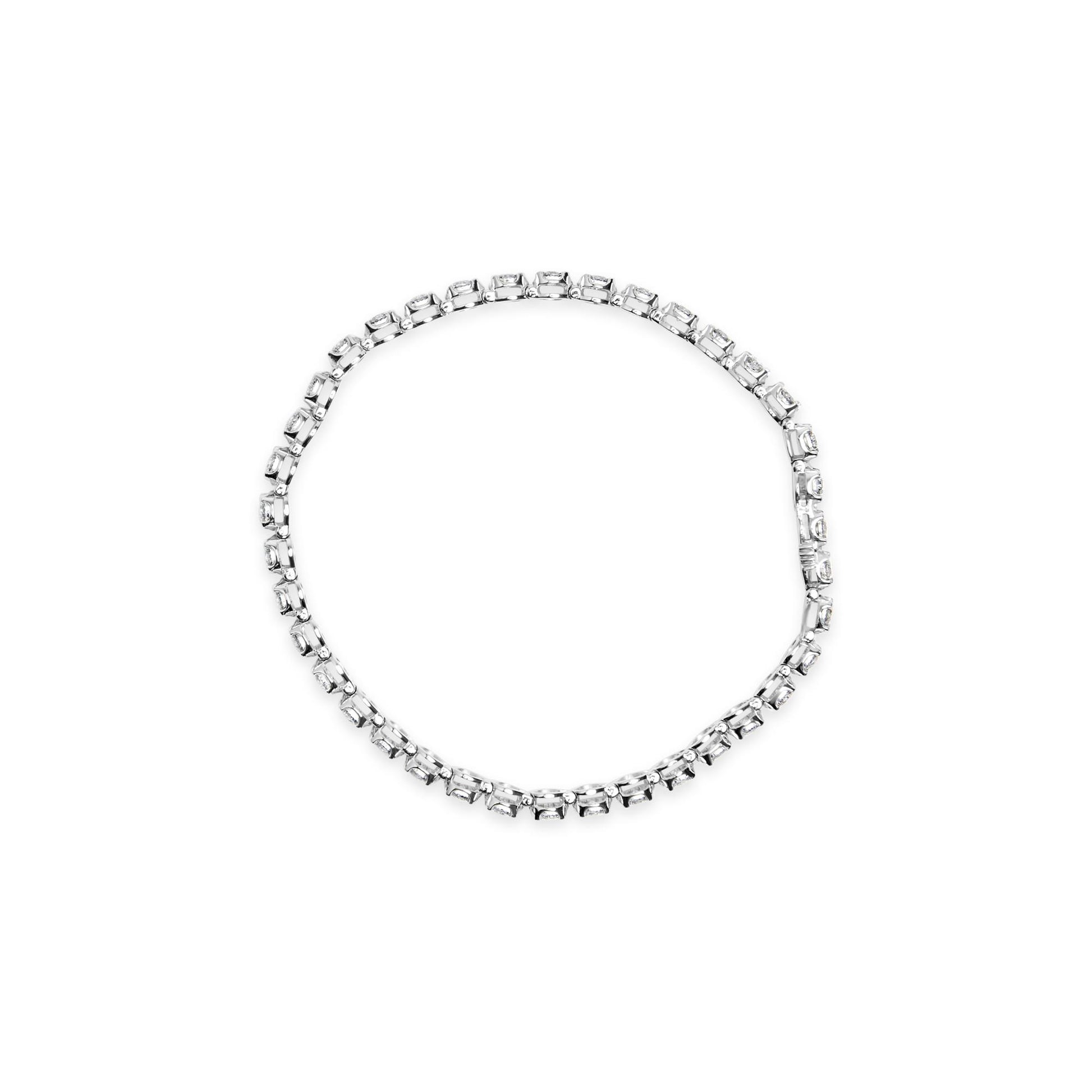 Top-down view of a white metal bracelet with round white gemstones in prong settings forming a circle.
