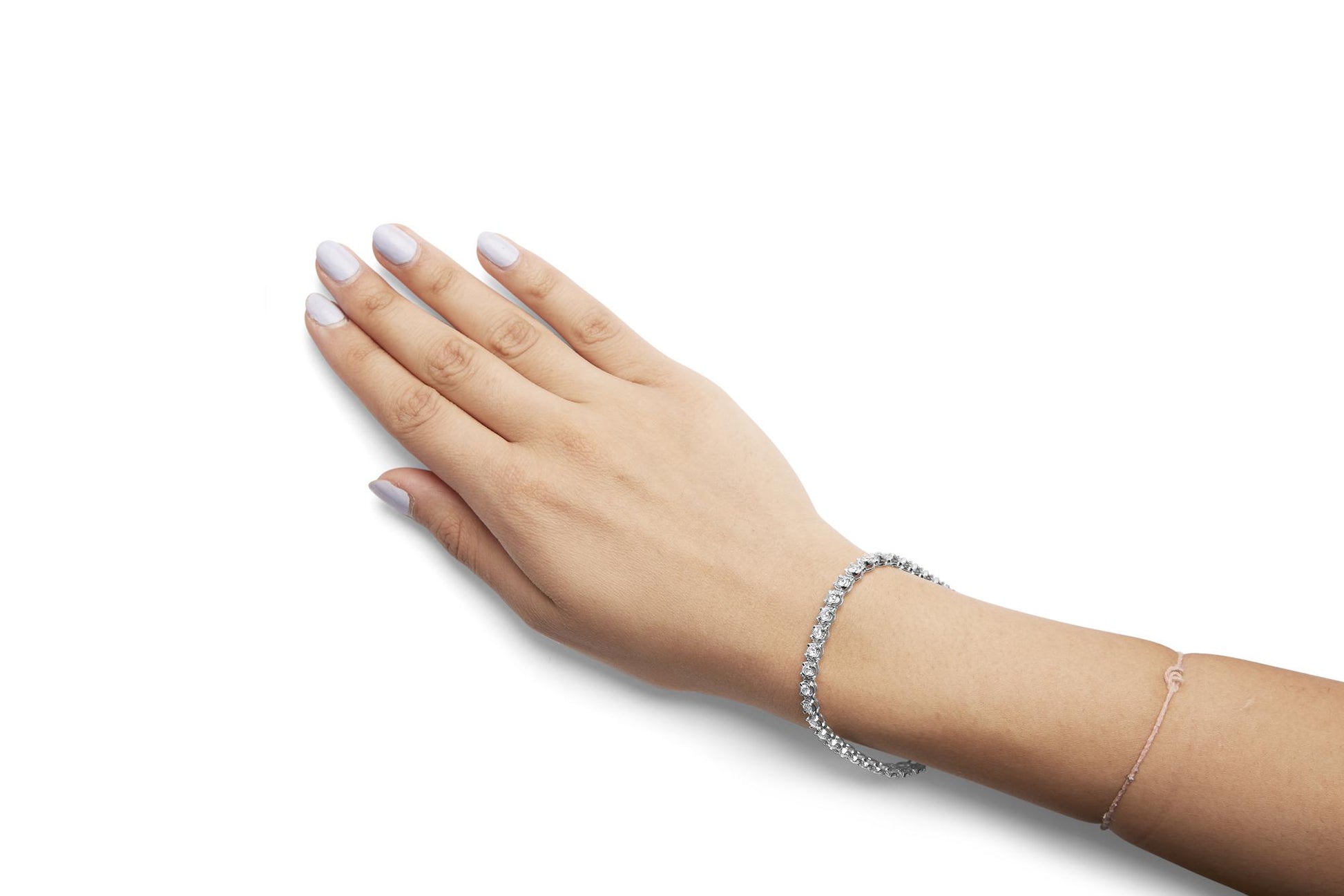 White metal bracelet with round white gemstones in prong settings on a model's wrist, side angled view.
