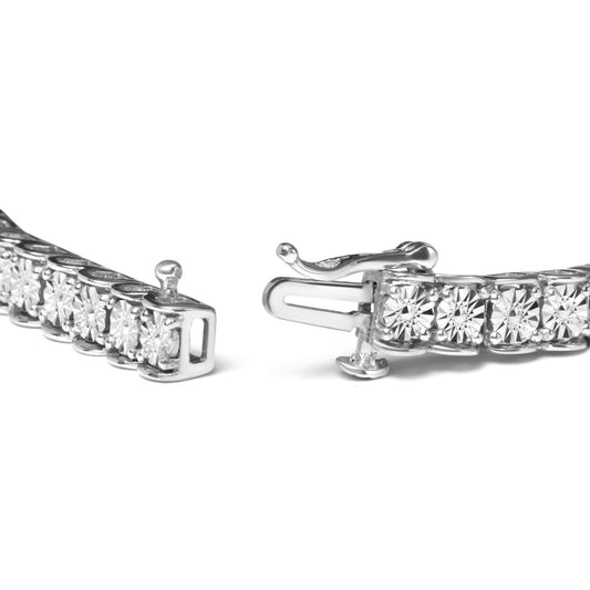 Close-up front angle of white metal bracelet with round white gemstones in miracle setting, showing open clasp.