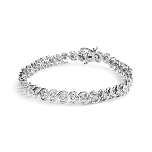 White metal bracelet with round white gemstones in a swirling design, shown in a front angle shot.