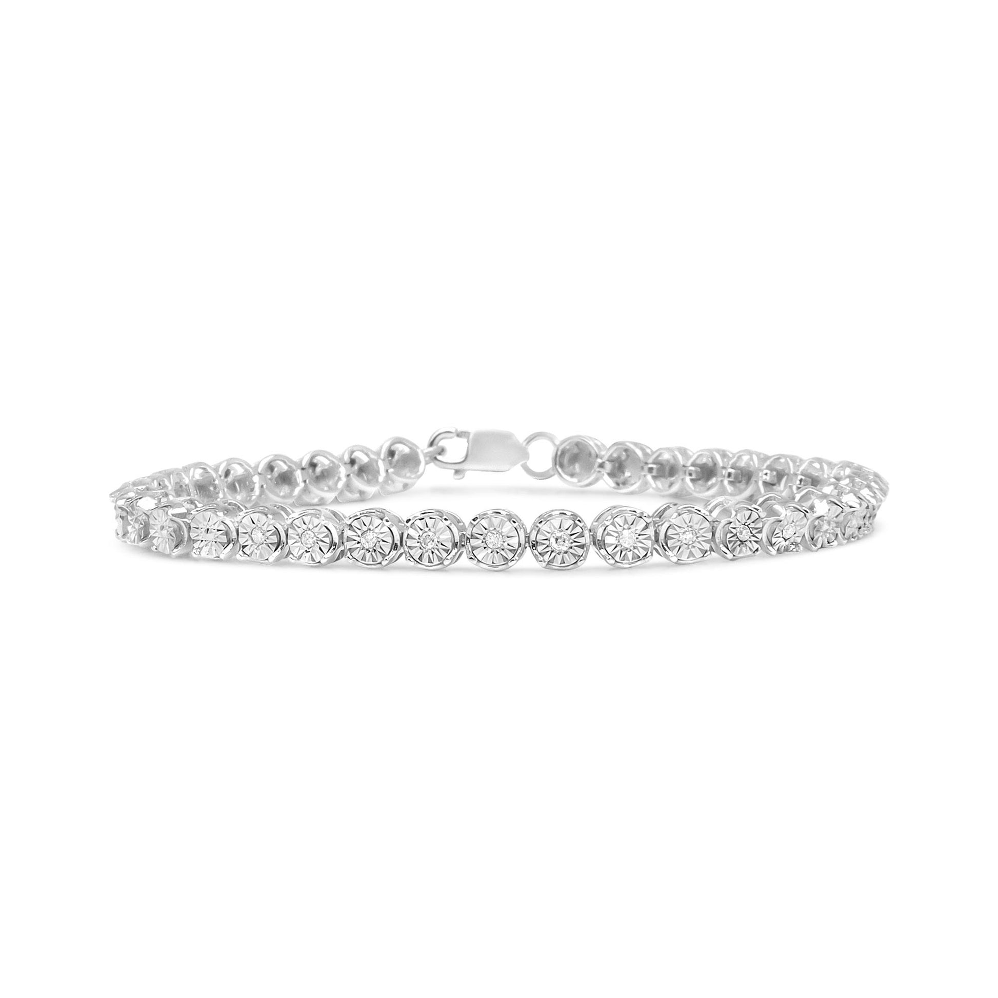 White metal bracelet with round white gemstones in miracle setting, photographed from front angle on white background.