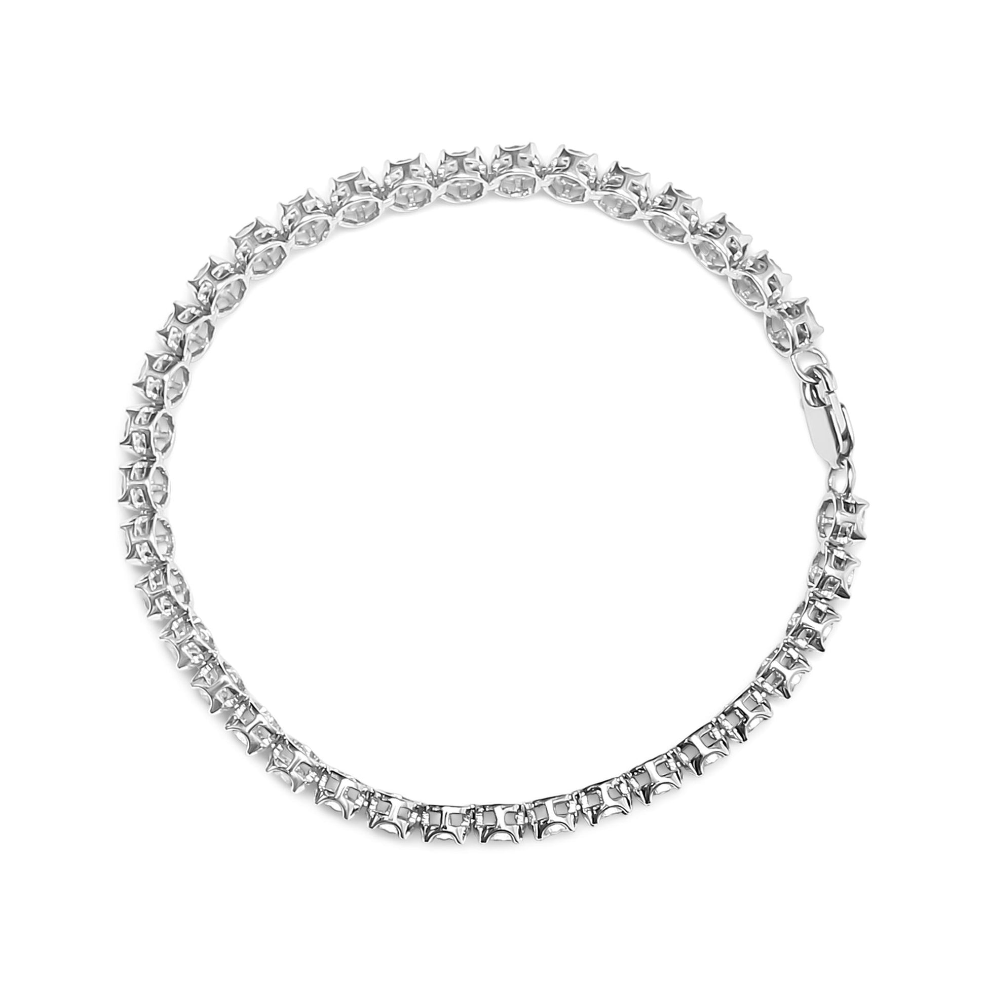 Top-down view of a white metal bracelet with round white gemstones in a miracle setting forming a continuous circle, clasp visible.