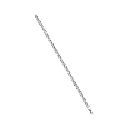 White metal bracelet with round white gemstones in miracle settings, photographed from an angled top-down view.