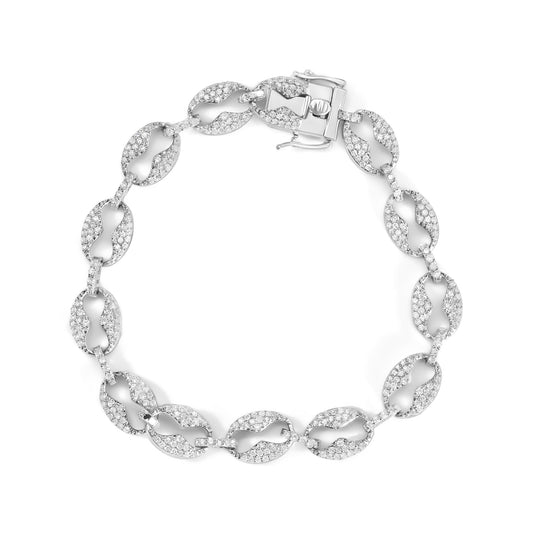 White metal bracelet with oval-shaped links featuring numerous round white gemstones in prong settings, shown from a top-down angle.