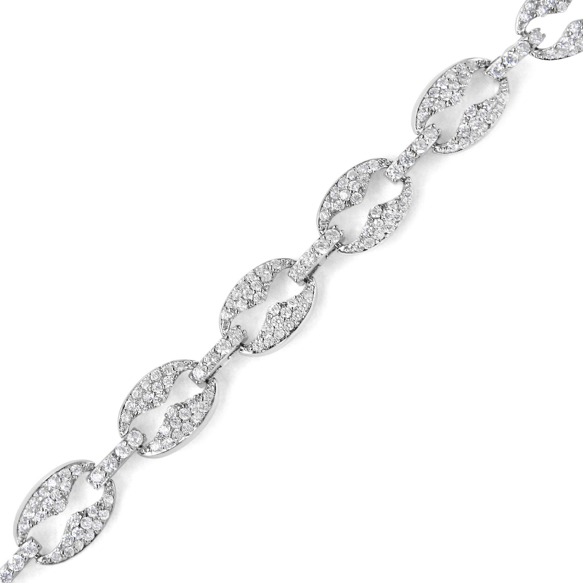 Close-up image of a white metal bracelet with alternating large oval links and smaller rectangular connectors, all adorned with round white gemstones in prong settings, displayed diagonally on a white background.