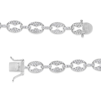 Close-up top-down view of a white metal bracelet featuring linked oval and bar segments encrusted with multiple small white gemstones in prong settings, shown unclasped and laid flat on a white background.