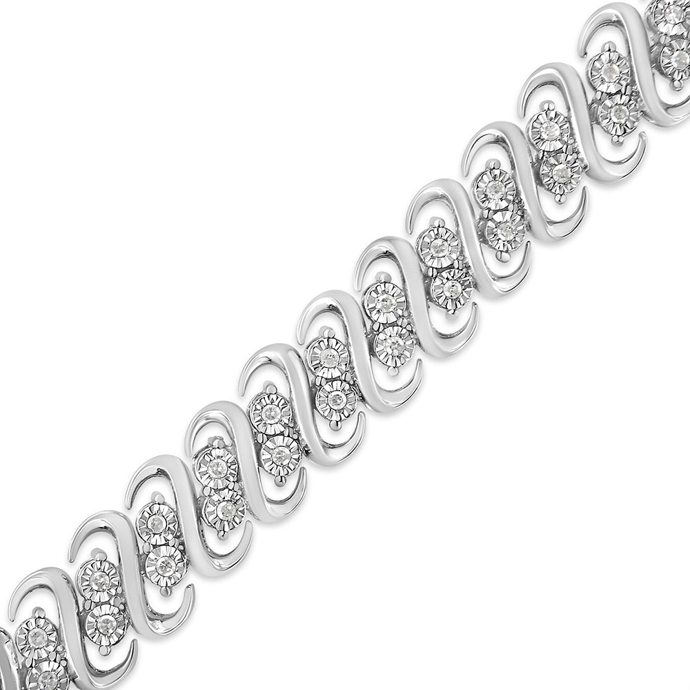 Diagonal close-up of a white metal bracelet featuring a repeating wave design set with clusters of round white gemstones.