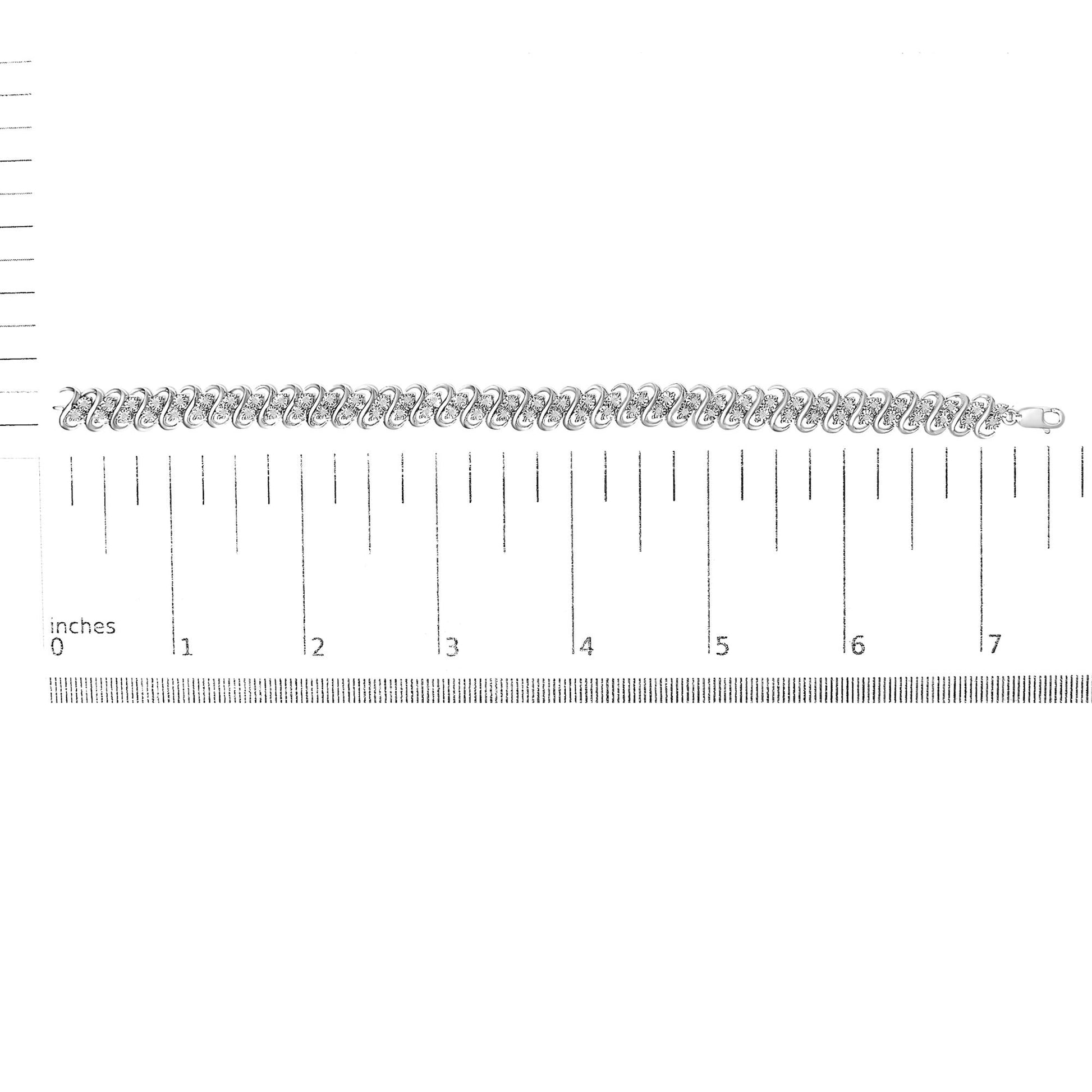 White metal bracelet with round white gemstones set in a miracle setting, laid flat on a ruler for size reference, top-down angle.
