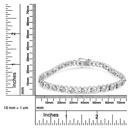 White metal bracelet with alternating curved links and round white gemstones in miracle setting, displayed on a ruler for size reference, shown from front angle.