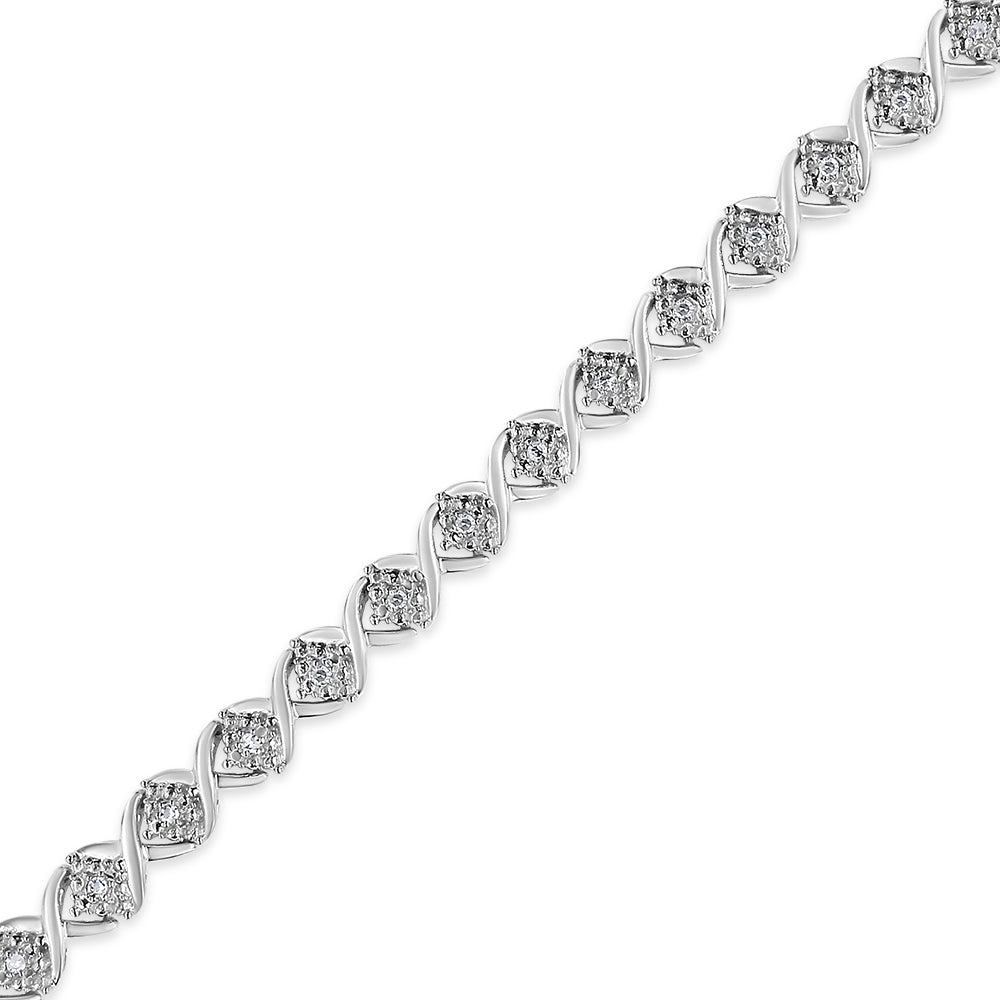 White metal bracelet with round white gemstones in prong settings, shown in a diagonal close-up view.
