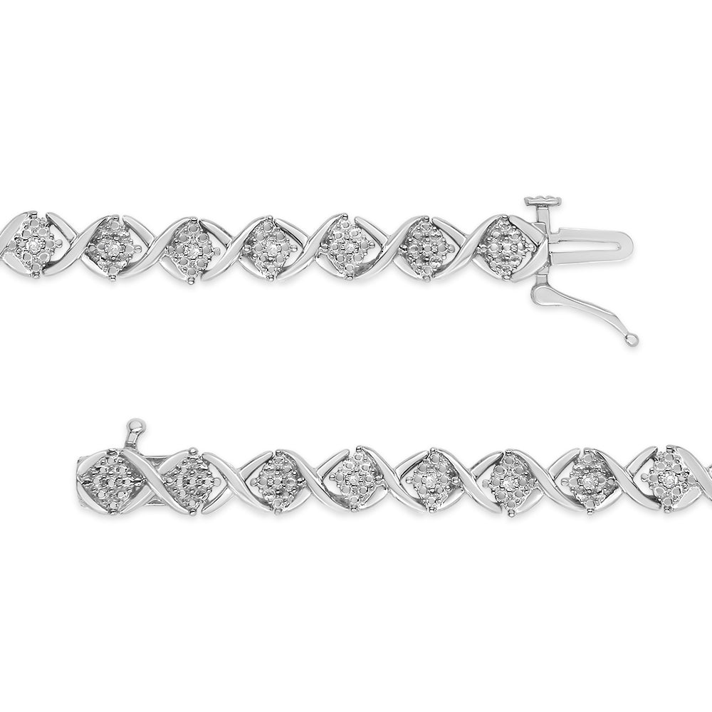 Top-down view of two white metal bracelets featuring alternating twisted links and cluster settings with round white gemstones, one bracelet slightly above the other.
