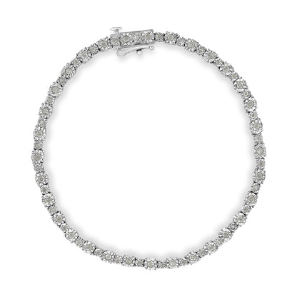 Top-down view of a white metal bracelet featuring round white gemstones in a miracle setting.
