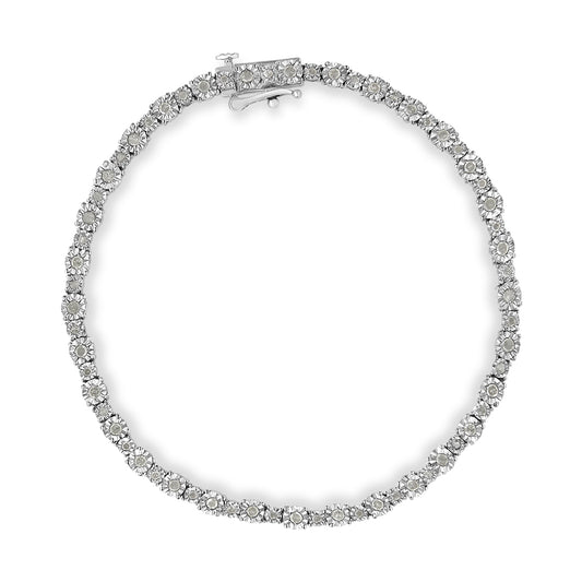 Top-down view of a white metal bracelet featuring round white gemstones in a miracle setting.