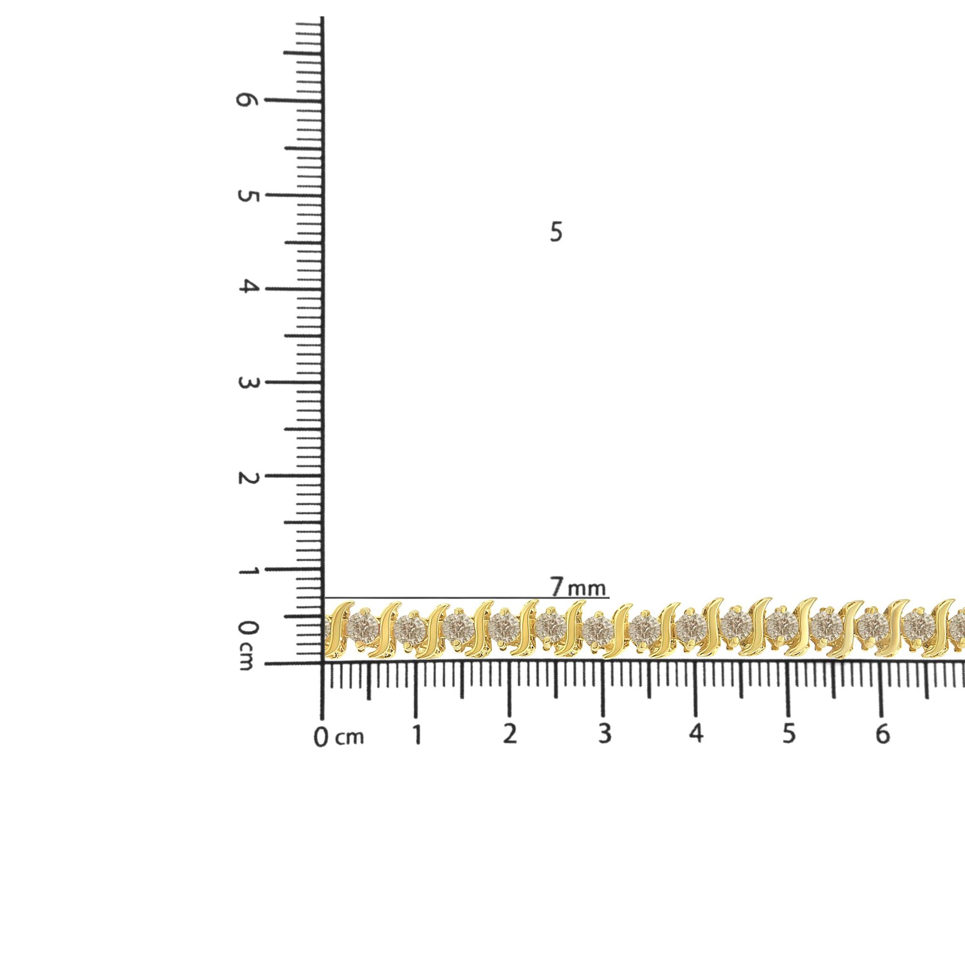 Yellow metal bracelet with round white gemstones in prong settings, shown lying flat on ruler for size reference, angled from above.