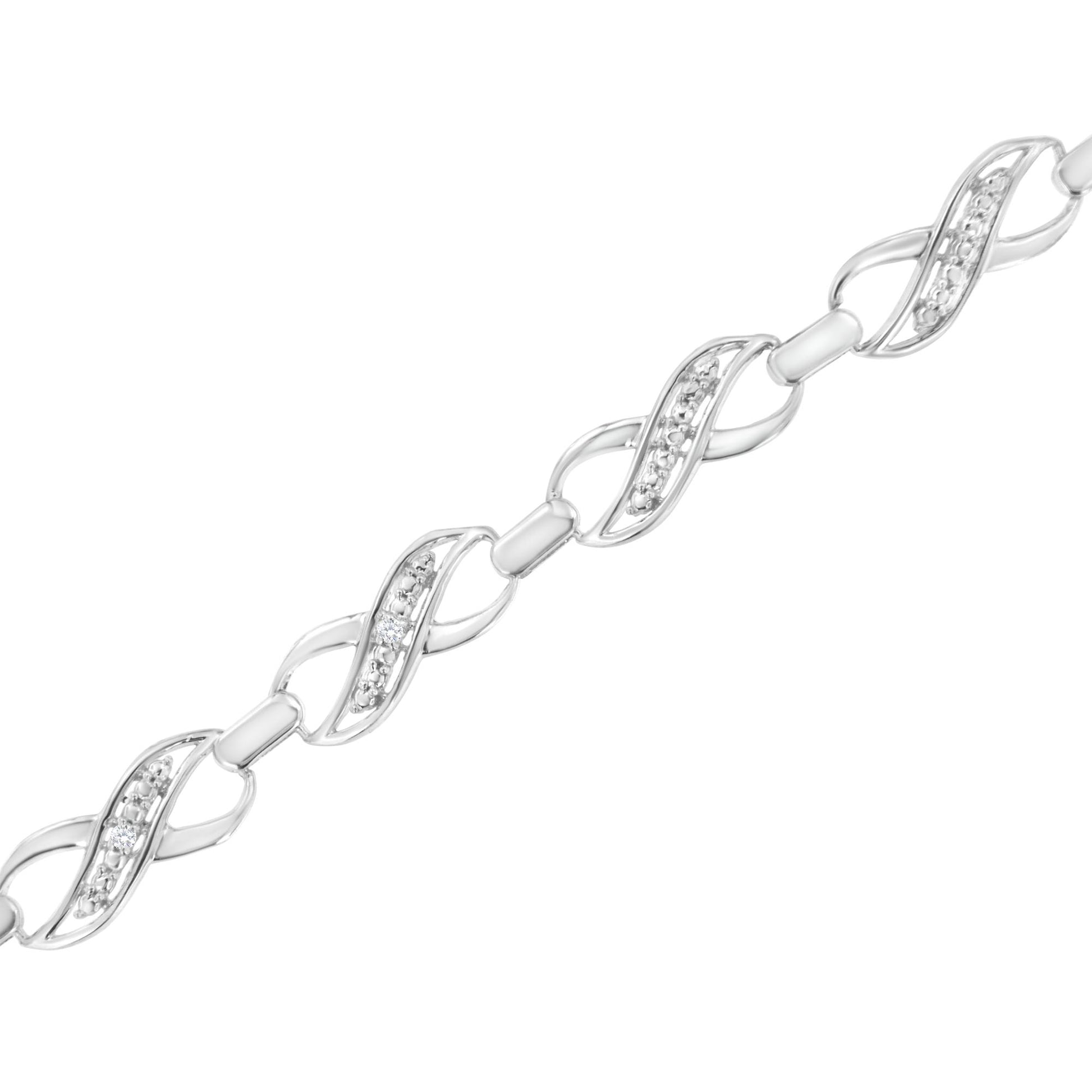 Diagonal close-up of a white metal bracelet featuring linked infinity-shaped segments, each set with small round white gemstones in prong settings.