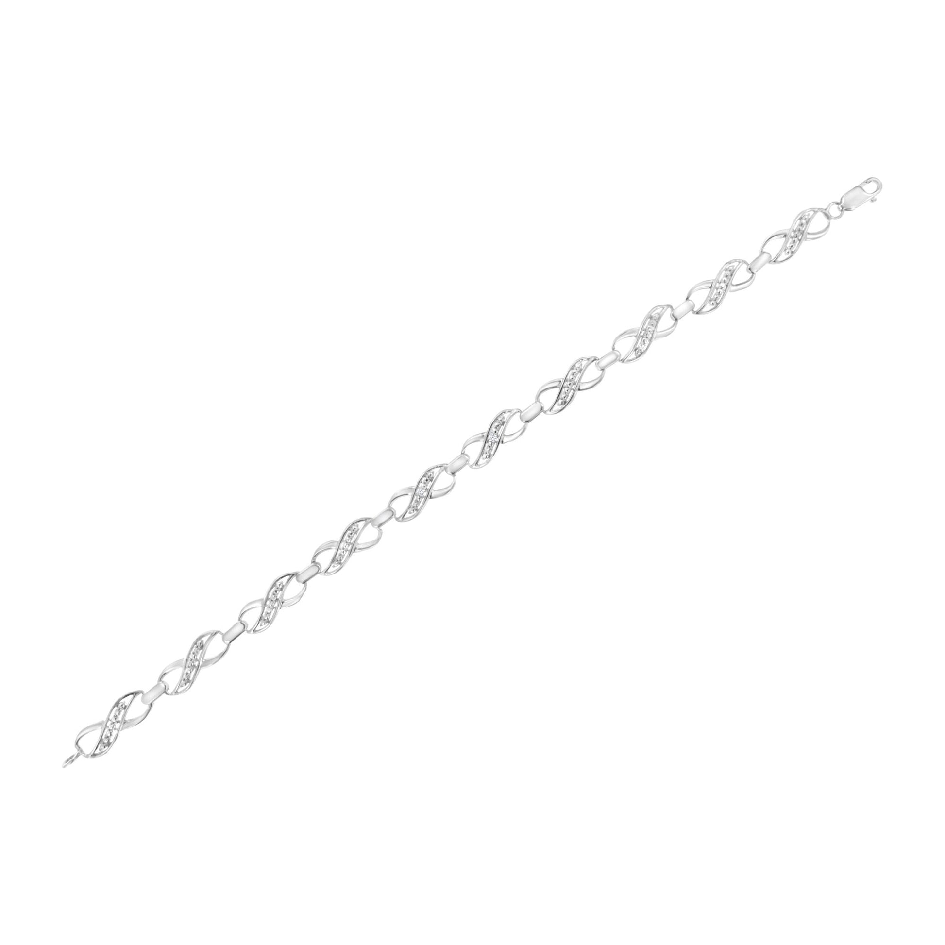 White metal bracelet with alternating twisted links set with small white round gemstones in prong settings, shown in a top-down flat lay angle.