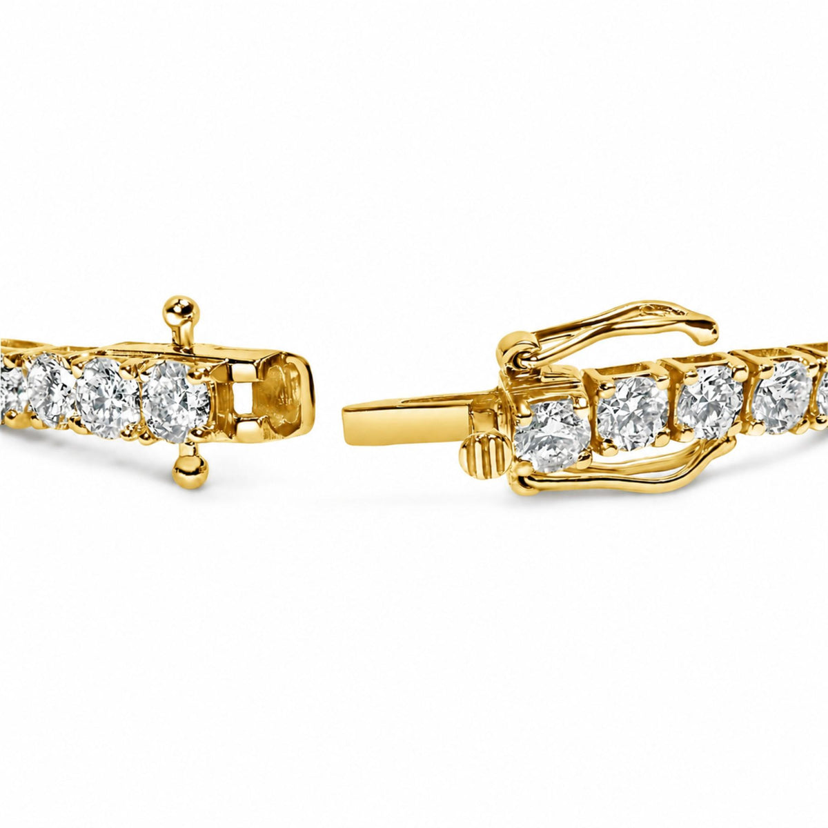 Close-up front angle of a yellow bracelet clasp featuring round white gemstones in a 4-prong setting.