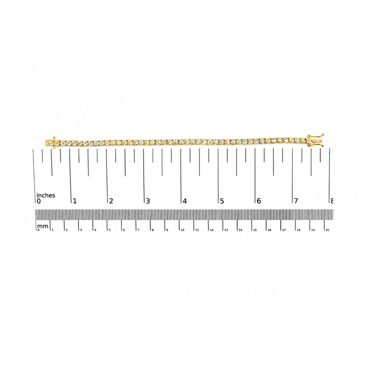 Yellow metal bracelet with small white round gemstones in a 4-prong setting, shown flat on a ruler scale from a top-down angle.