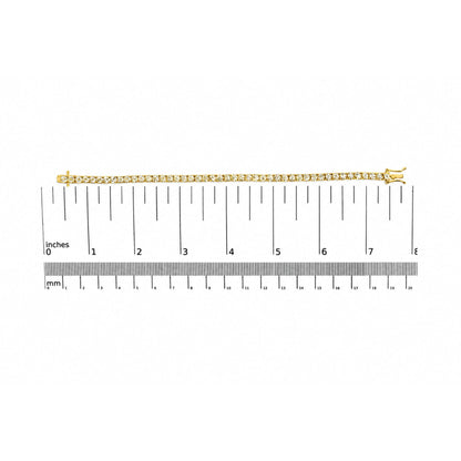 Yellow metal bracelet with small white round gemstones in a 4-prong setting, shown flat on a ruler scale from a top-down angle.