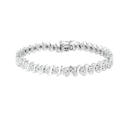 Bracelet in white metal with round white gemstones in a miracle setting, shown at a slight angle on a white background.