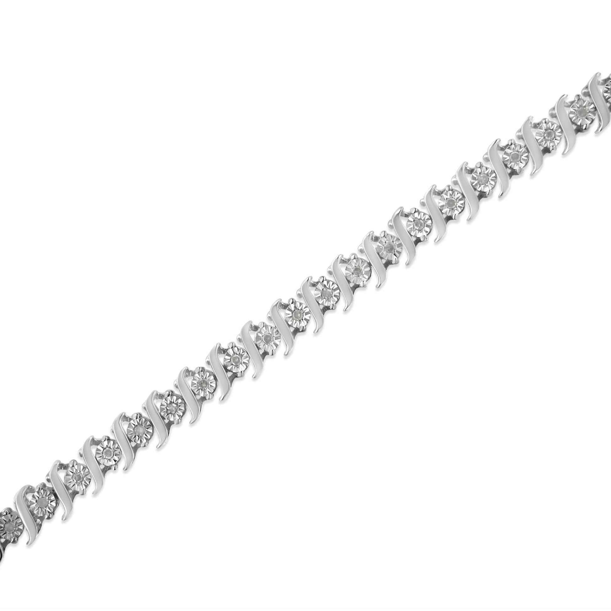 Diagonal close-up of a white metal bracelet featuring round white gemstones in a miracle setting.