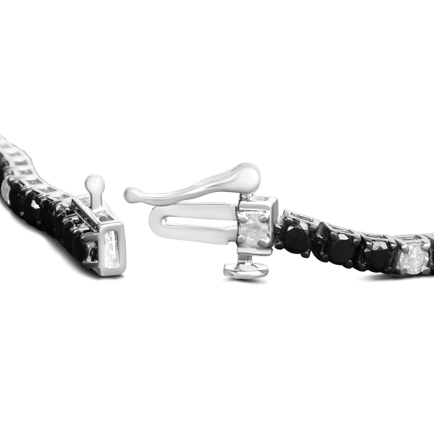 Close-up front angle of a white metal bracelet with alternating black and white round gemstones in 4-prong settings and a visible clasp.