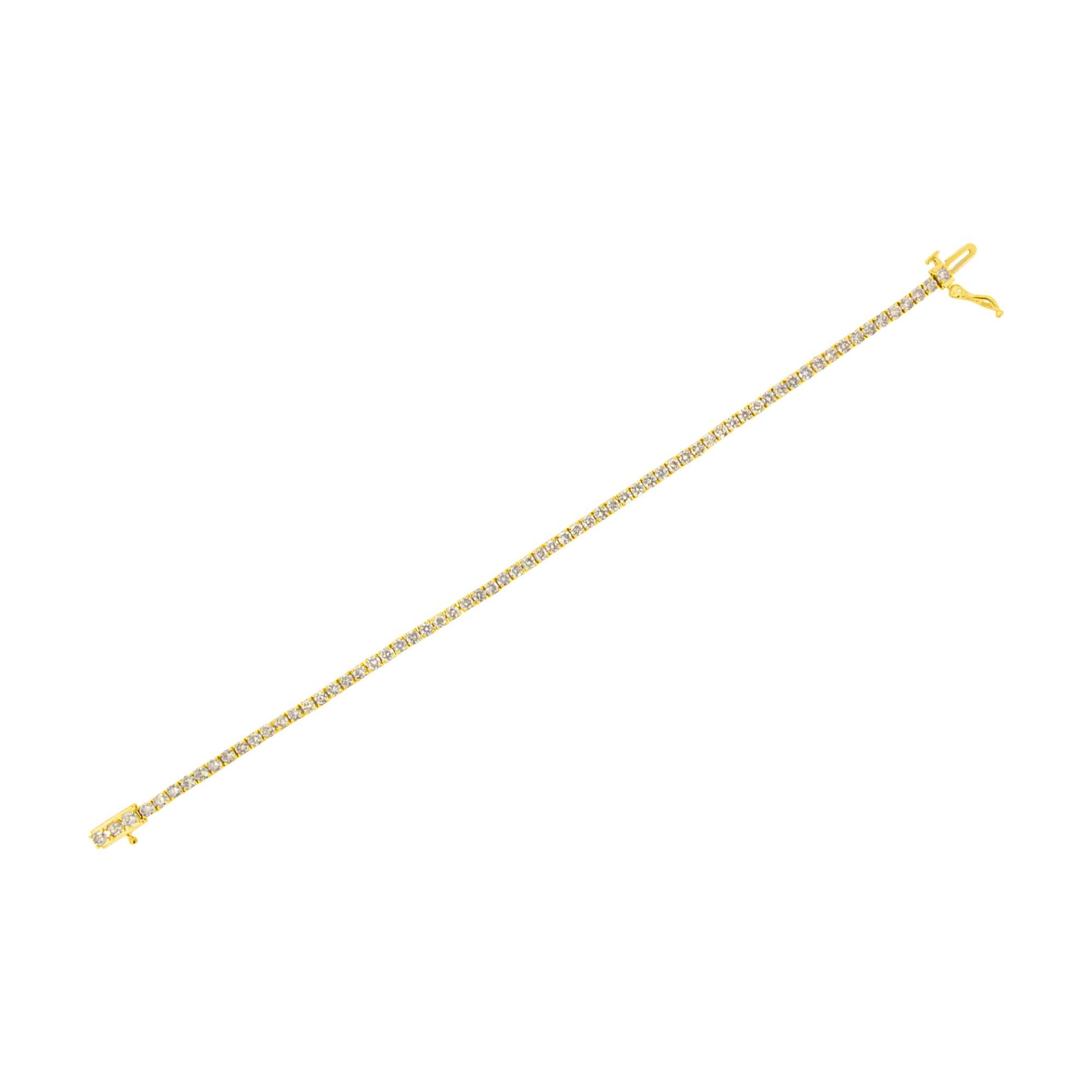 Yellow metal bracelet with round white gemstones in prong settings, shown from a top flat angle.