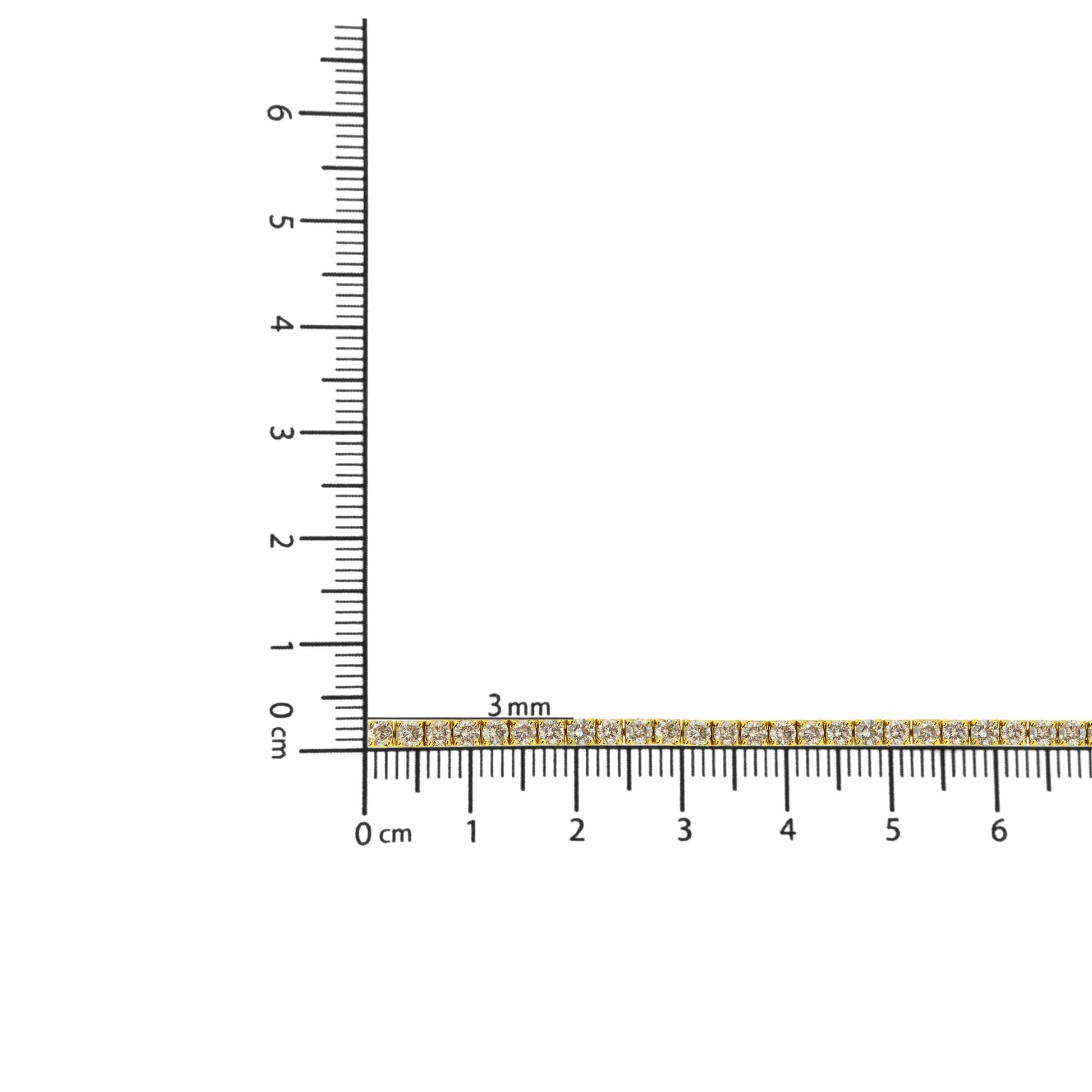 Yellow bracelet with round brownish gemstones in prong settings, shown horizontally on a ruler for size reference.