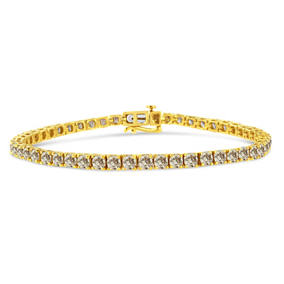 Yellow metal bracelet with round brownish gemstones in prong setting, shown from a front angle on a white background.