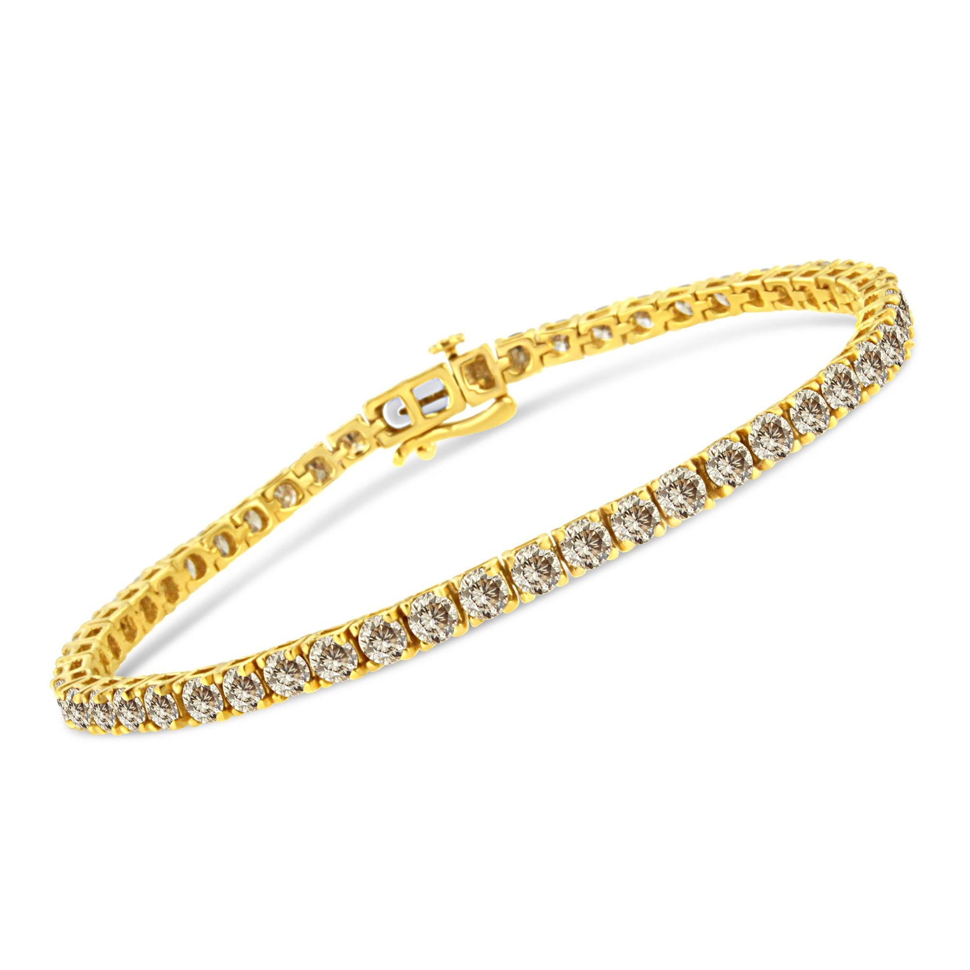Yellow metal bracelet with brownish round gemstones in prong setting, shown at an angled close-up.