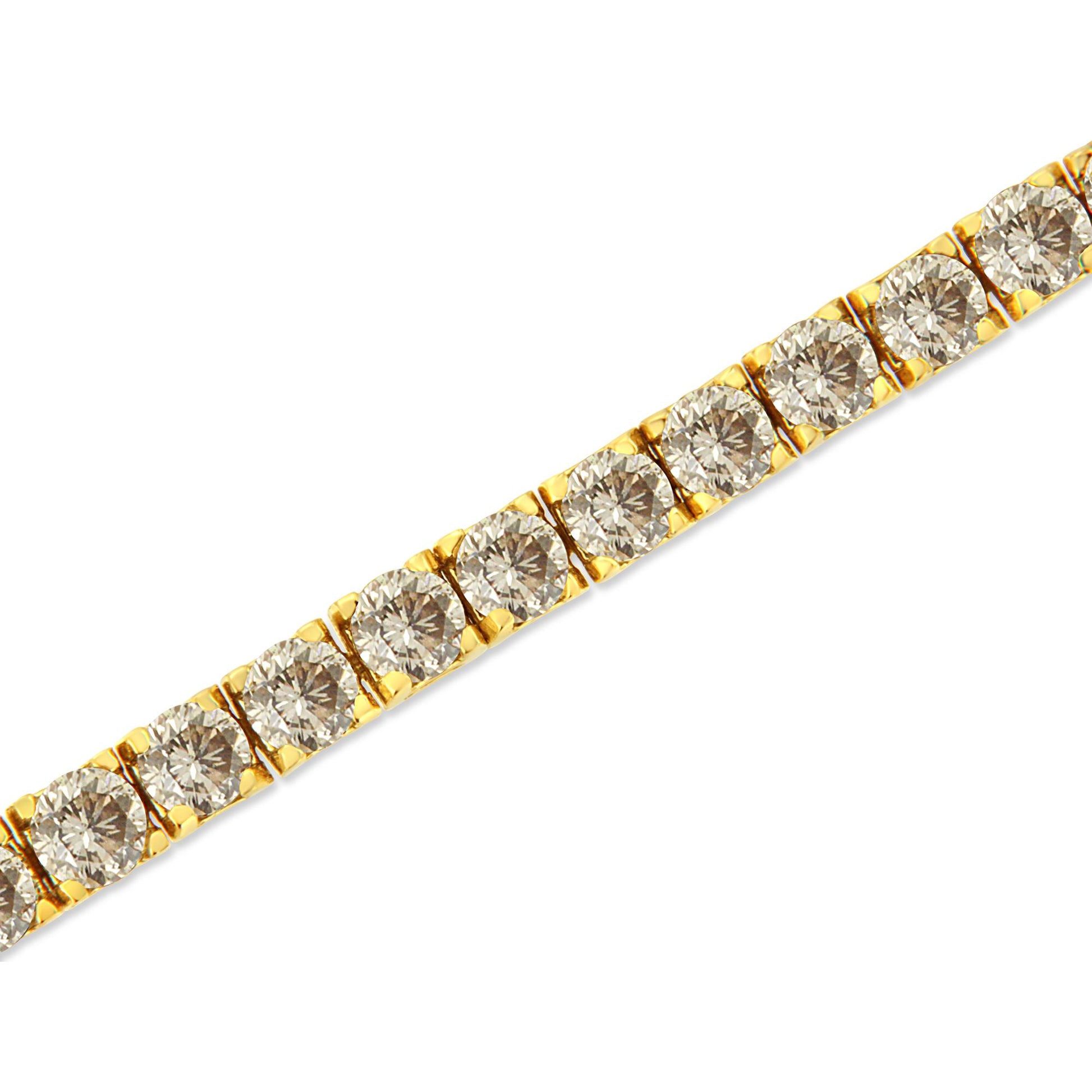 Close-up diagonal shot of a yellow metal bracelet with round brownish gemstones in prong settings.
