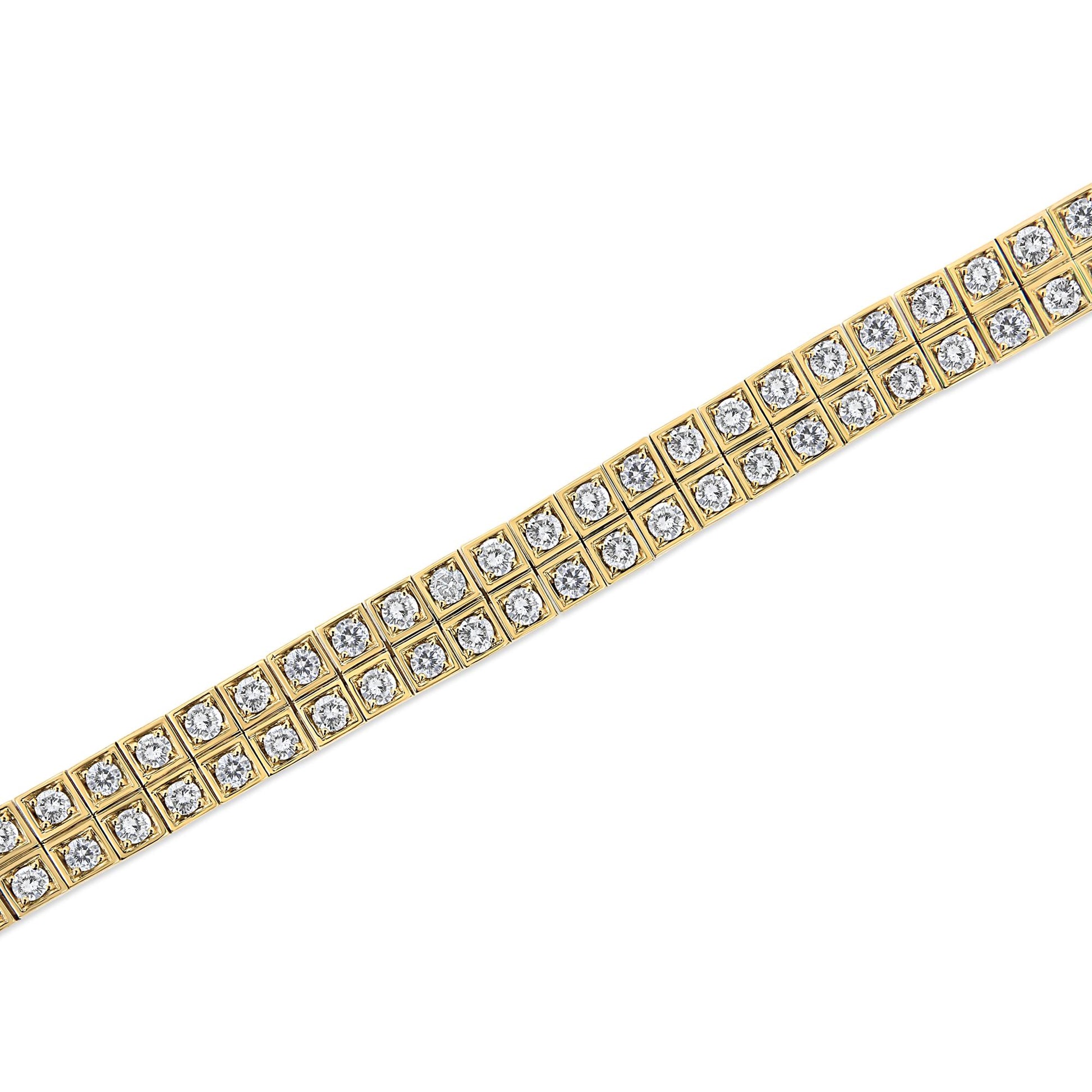 Diagonal close-up shot of a yellow metal bracelet with two rows of round white gemstones in prong settings.