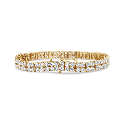 Yellow metal bracelet with round brownish gemstones in 4-prong settings, shown in a front angle shot on a white background.