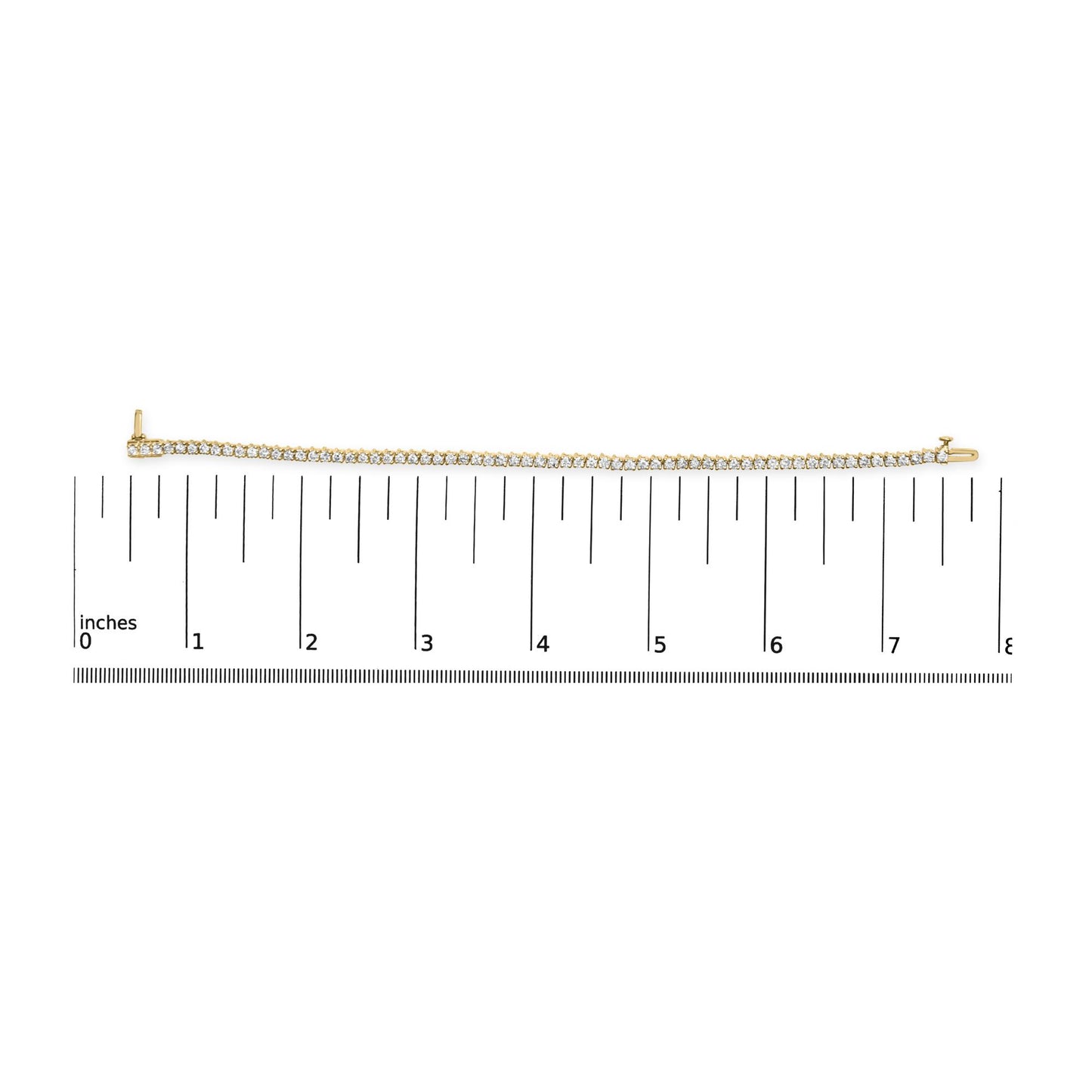 Yellow metal bracelet with prong-set round white gemstones, laid flat on ruler for size reference, top-down angle.