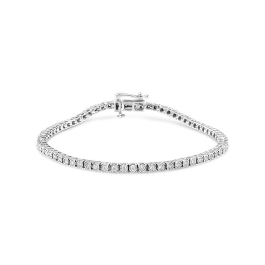 White metal bracelet with round white gemstones in a miracle setting, photographed from the front at a slight angle.