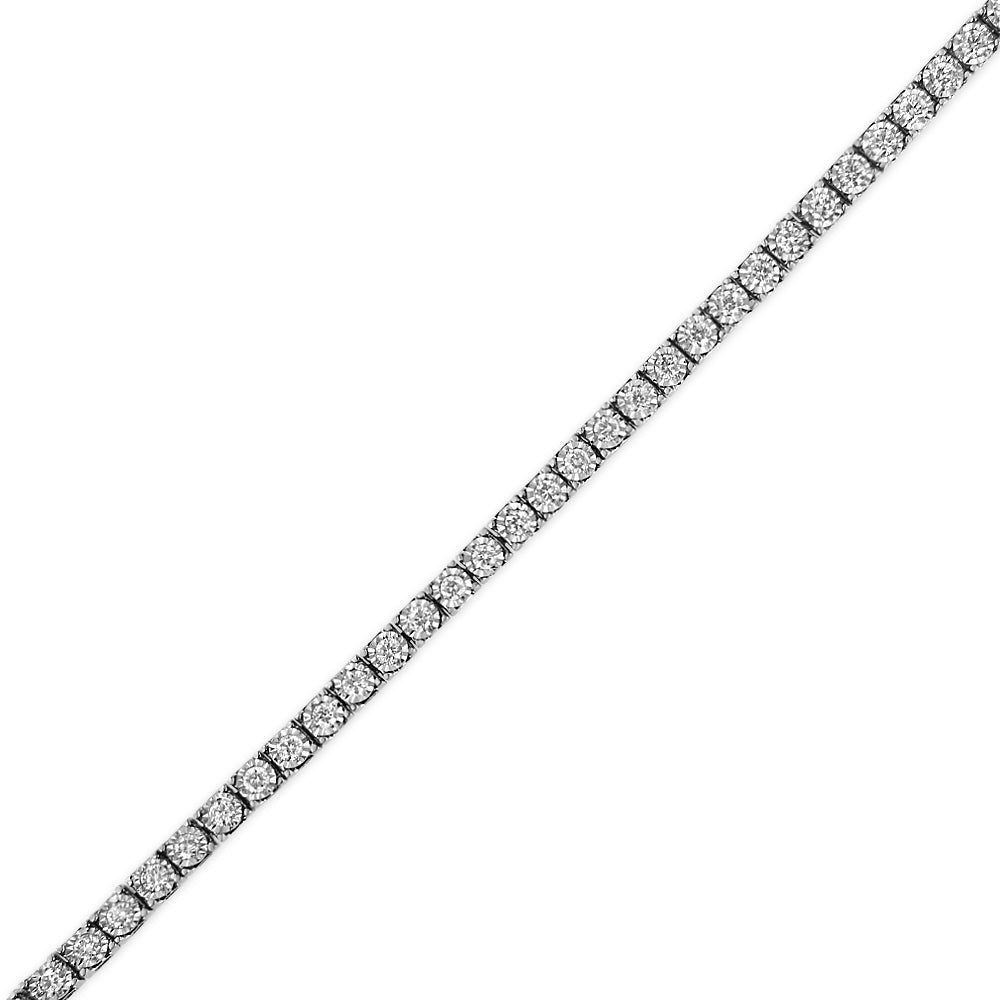 Diagonal close-up of a white metal bracelet featuring a row of round white gemstones in a miracle setting on a white background.