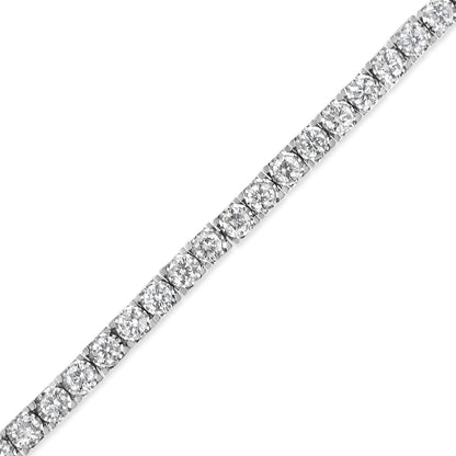 Close-up diagonal shot of a white metal bracelet featuring round white gemstones in a miracle setting.