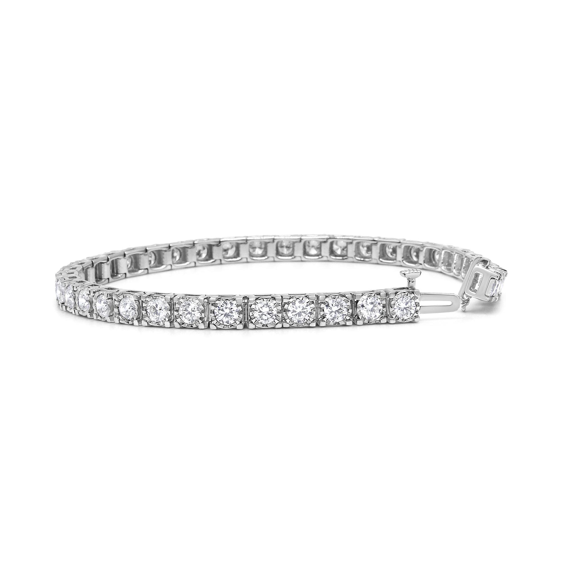 Close-up front angle of a white metal tennis bracelet featuring round white gemstones in a miracle setting.