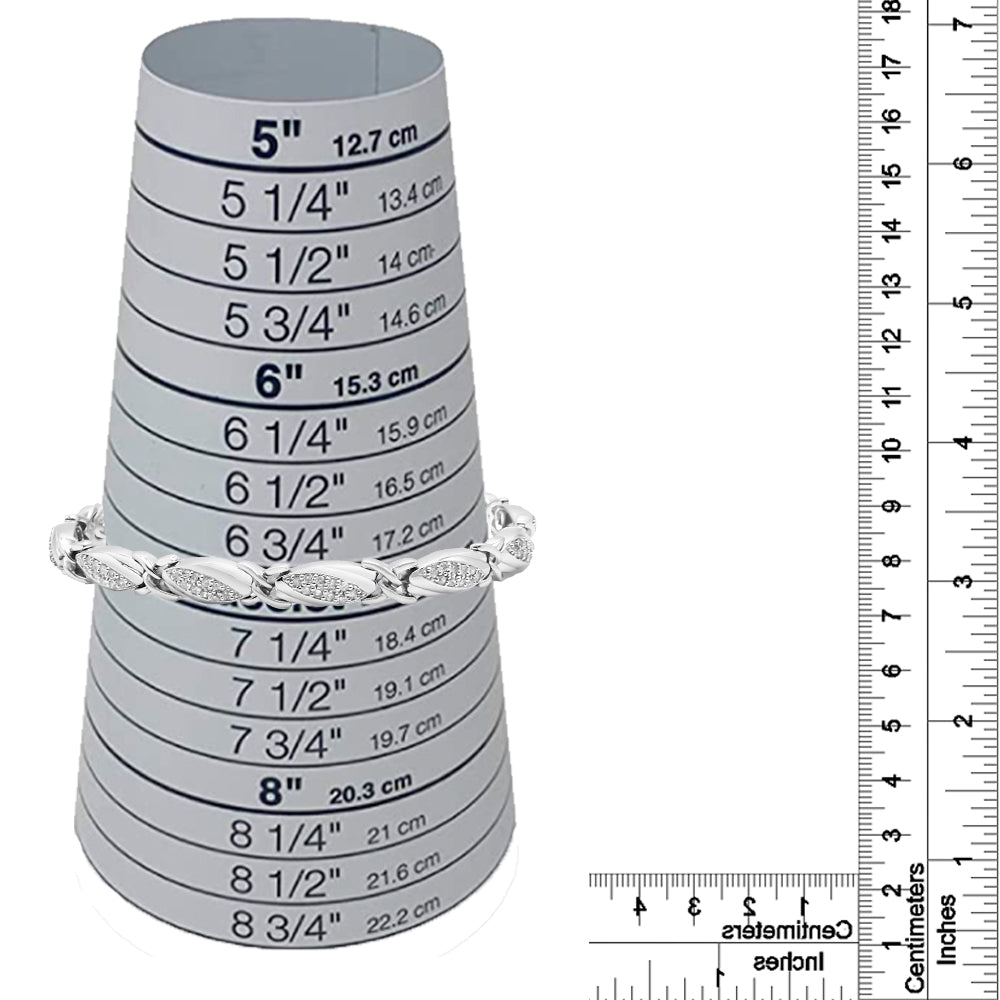 White bracelet with rounded links featuring multiple small white gemstones in prong settings, displayed on a measurement cone with rulers for size reference, shot from the front.