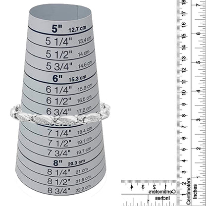 White bracelet with rounded links featuring multiple small white gemstones in prong settings, displayed on a measurement cone with rulers for size reference, shot from the front.