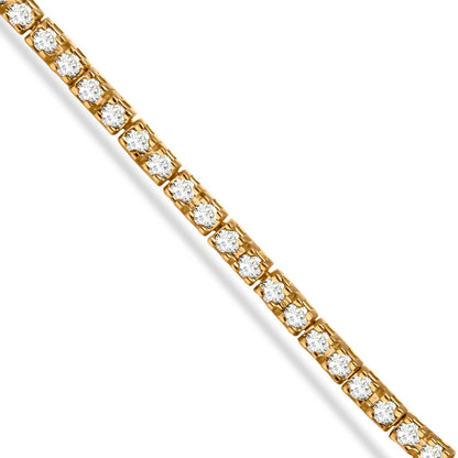 Diagonal close-up of a yellow bracelet with round champagne-colored gemstones in prong settings.