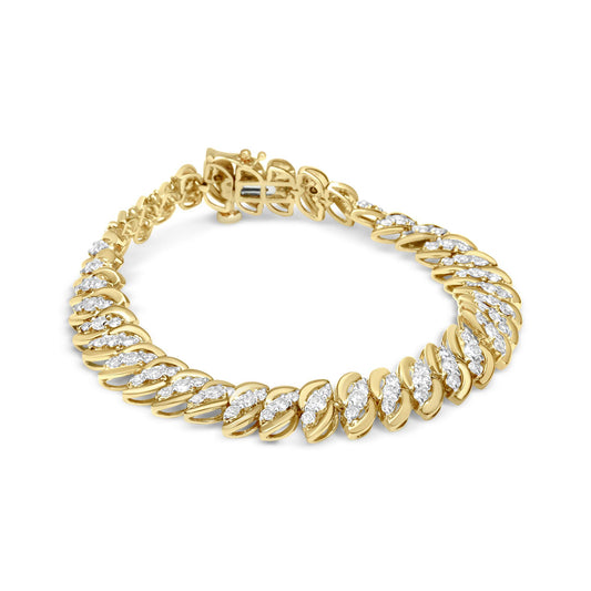 Top-down angled view of a yellow metal bracelet featuring alternating links with clusters of white round gemstones in prong settings.