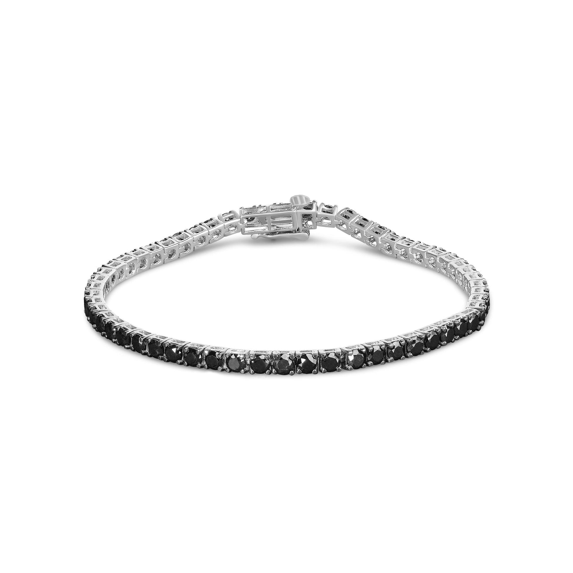 White metal bracelet with round black gemstones in prong settings, shown at a slight angle on a white background.