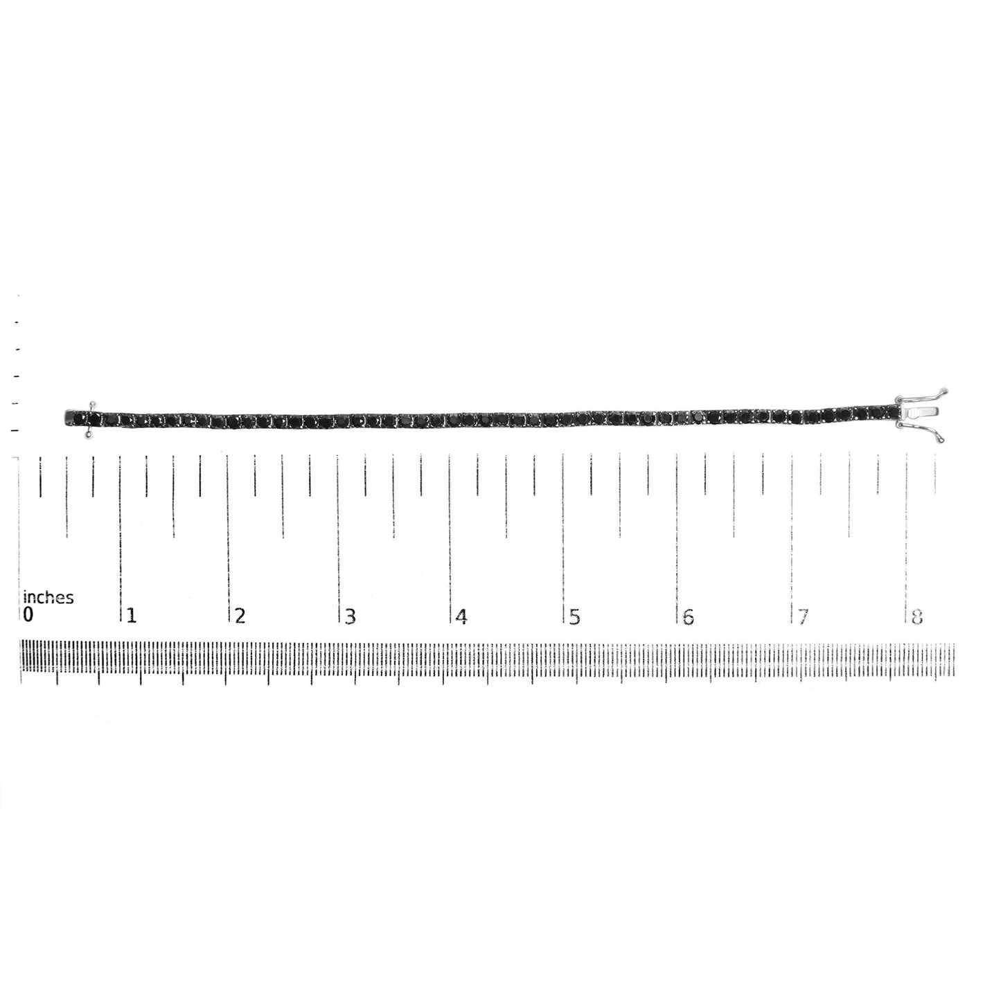 White metal bracelet with black round gemstones in prong settings, laid flat on a ruler for size reference, shot from above.