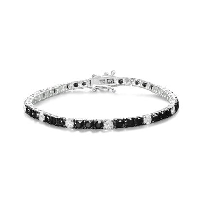 White metal bracelet with alternating black and white round gemstones in four-prong settings, shown from a slightly elevated front angle.